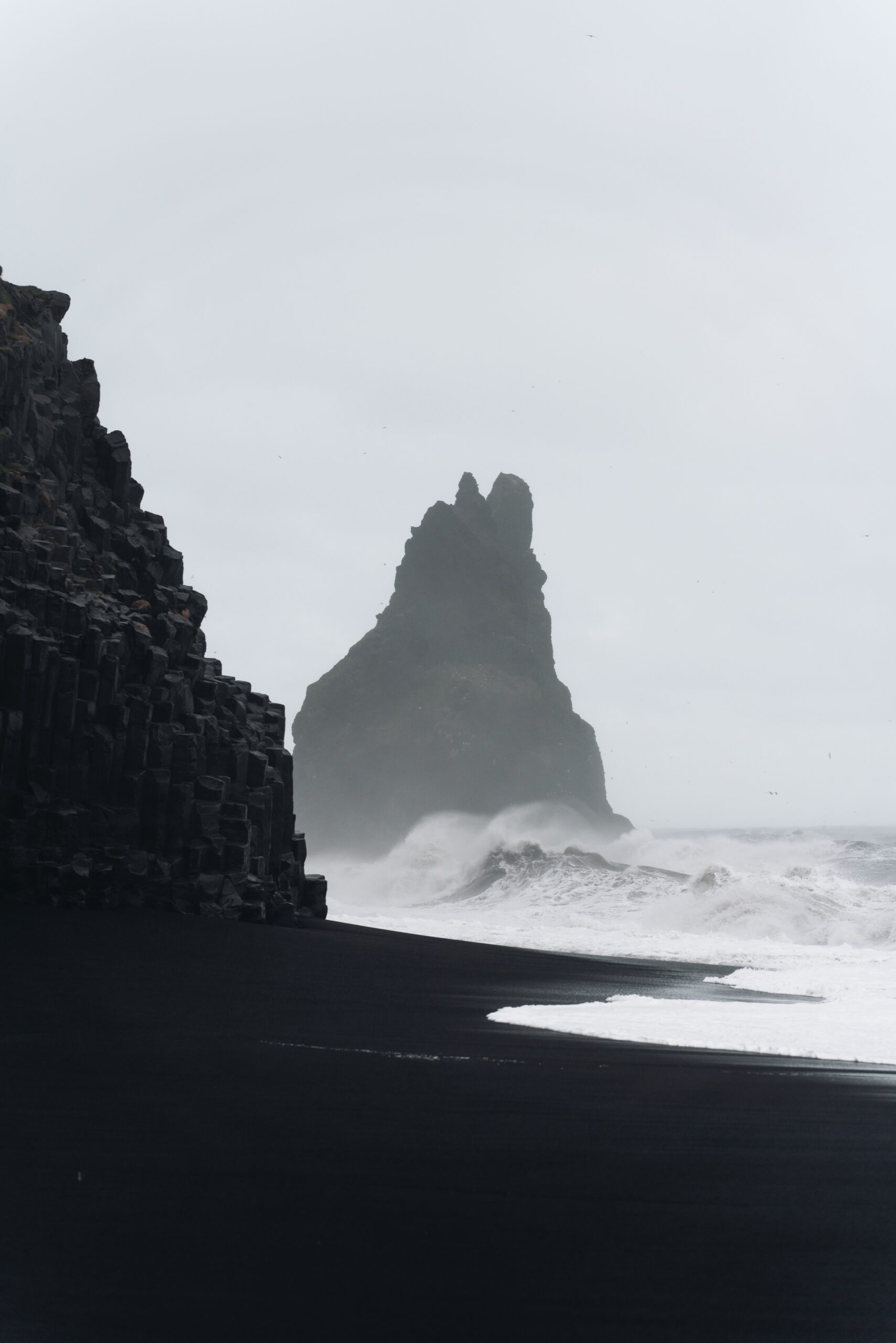 Djordje Vukojicic Photography captures the dramatic allure of the coast - a black sand beach adorned with waves crashing against the shore, creating a mesmerizing symphony of nature.