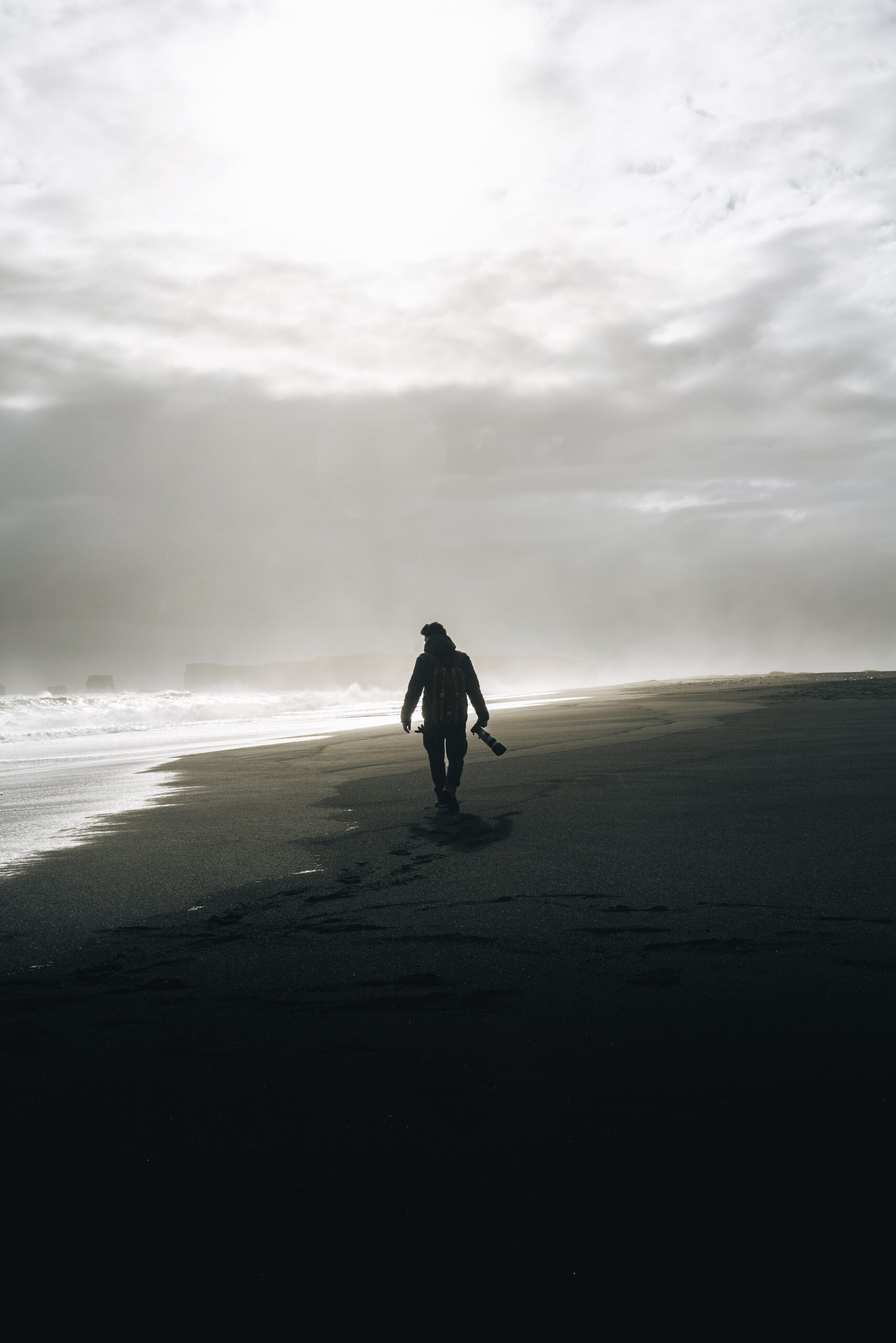  Djordje Vukojicic Photography presents a creative and ready-to-print image featuring a person walking on a beach, capturing the essence of serenity and exploration.