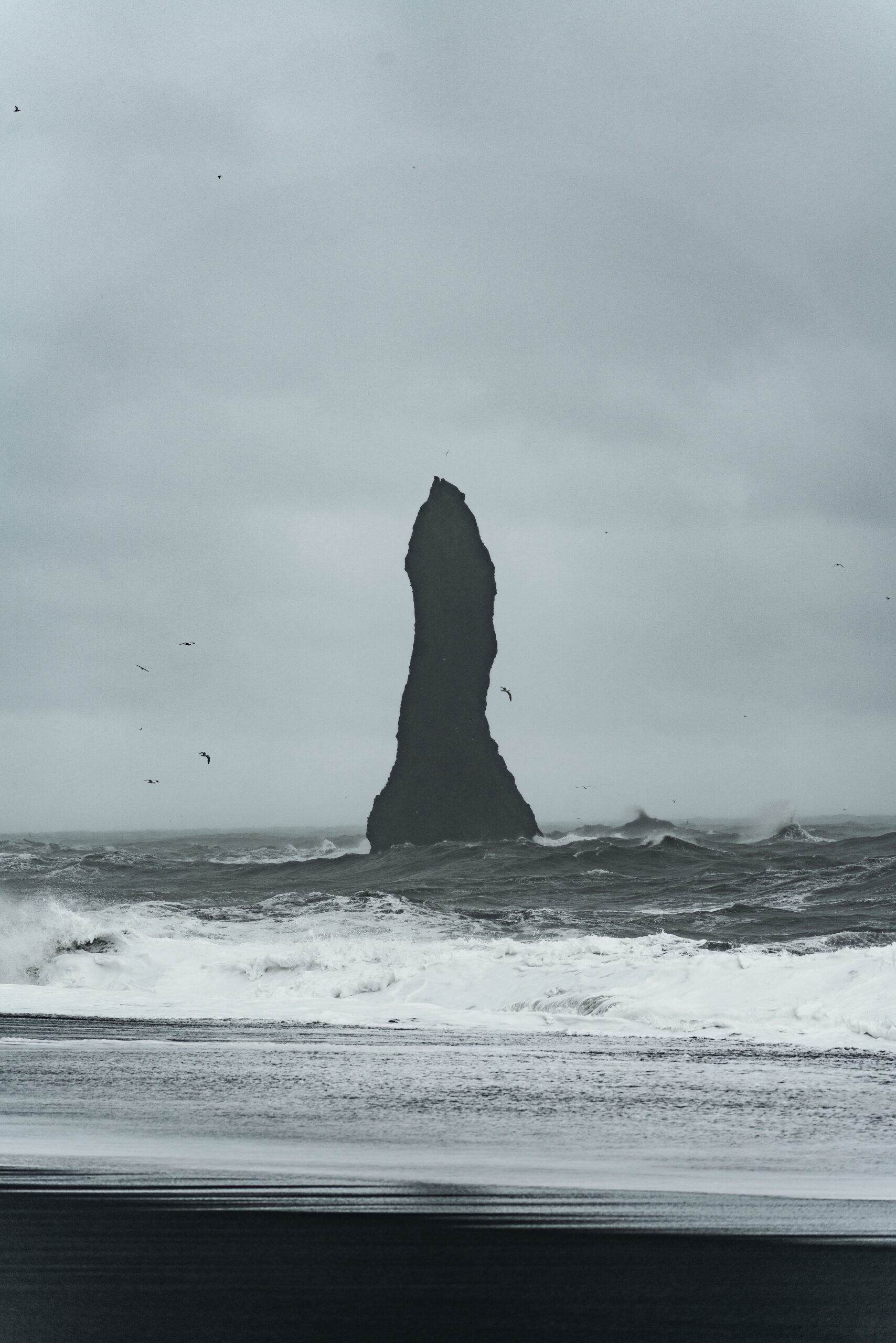 Djordje Vukojicic Photography captures the majestic isolation of nature - a large rock standing resilient in the midst of the vast and dynamic ocean.